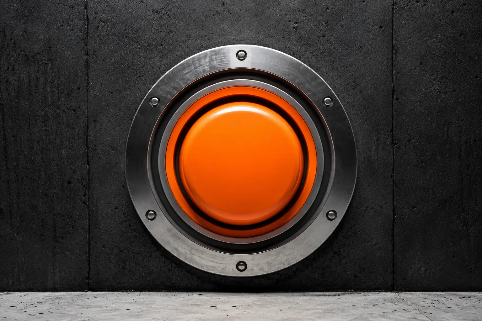 A large unbranded orange impact button mounted in black concrete